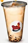 Vaso de bubble tea con bolitas en el fondo.